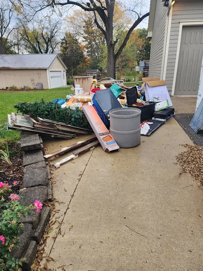 Dumpster being loaded with debris for Commercial Dumpster Rental in Oak Grove